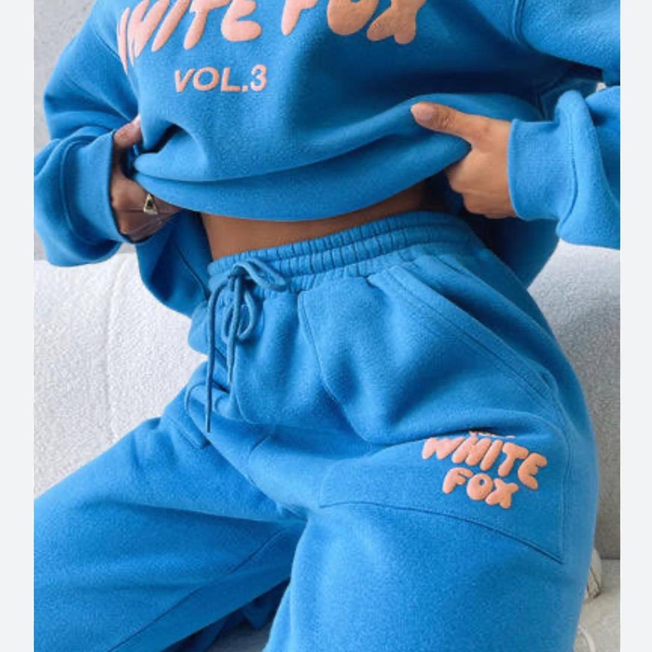 blue white fox boutique trackies with orange writing - Depop