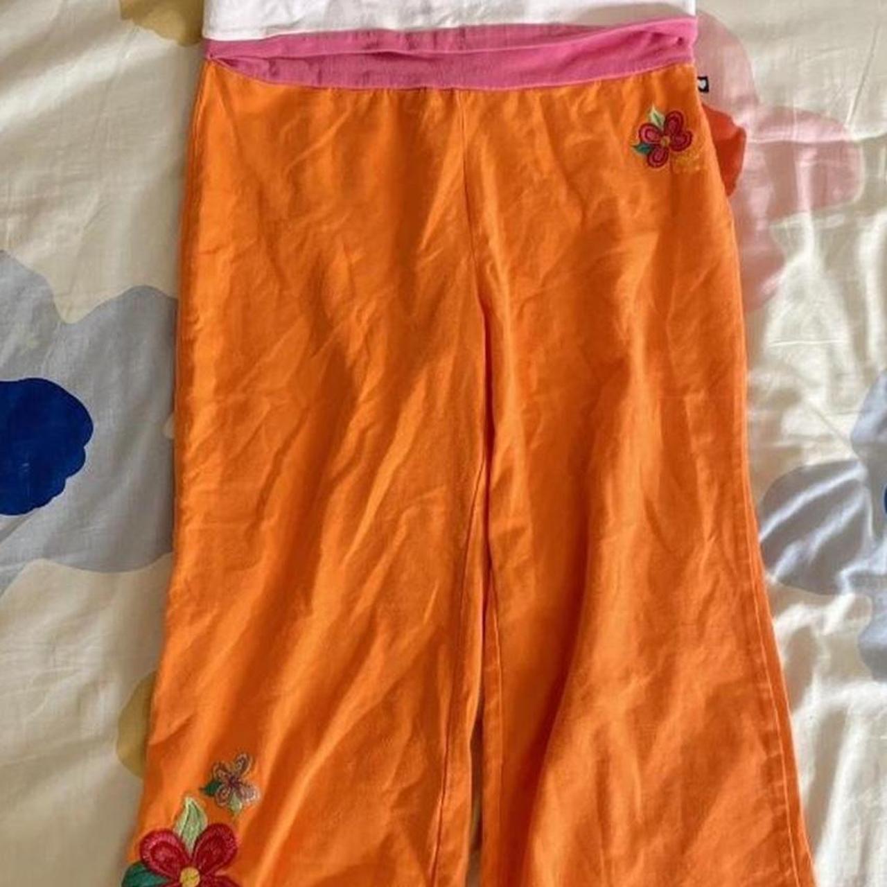 Orange capri pants with pink flower embroidered... - Depop
