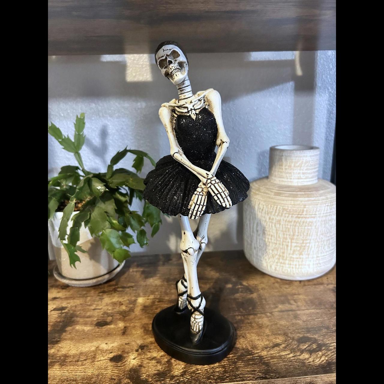 Skeleton arm holding rose by outlet Rachel Zoe