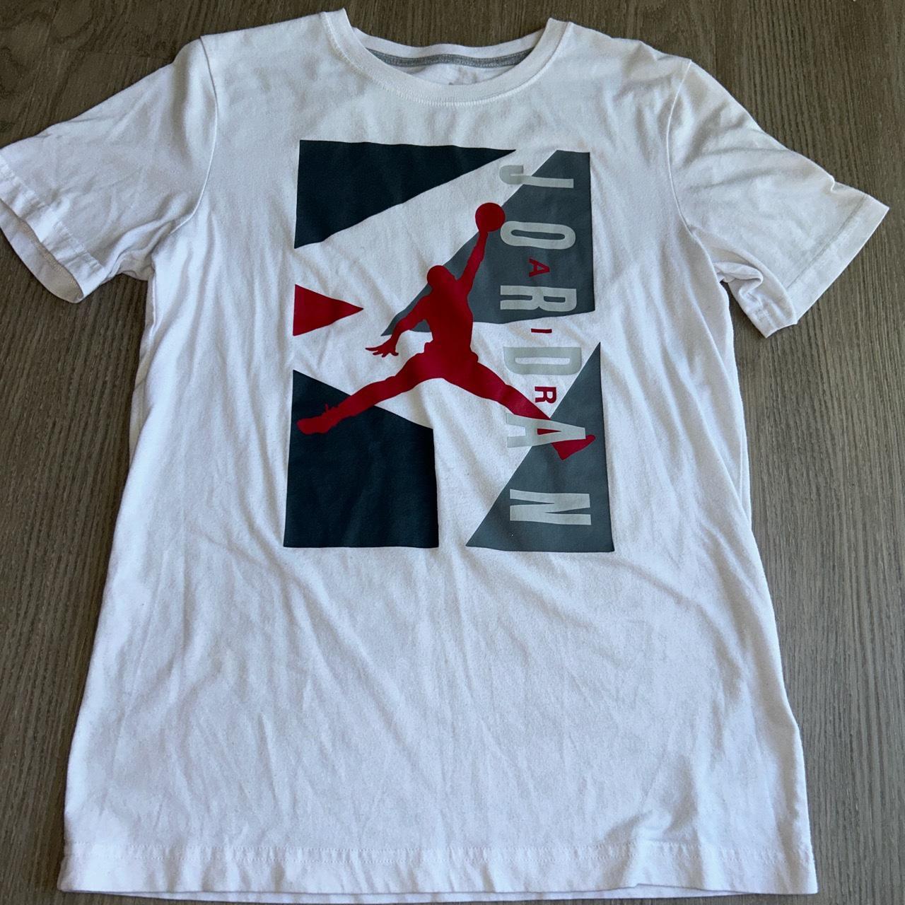 White Jordan shirt size xl in kids fits a medium in...