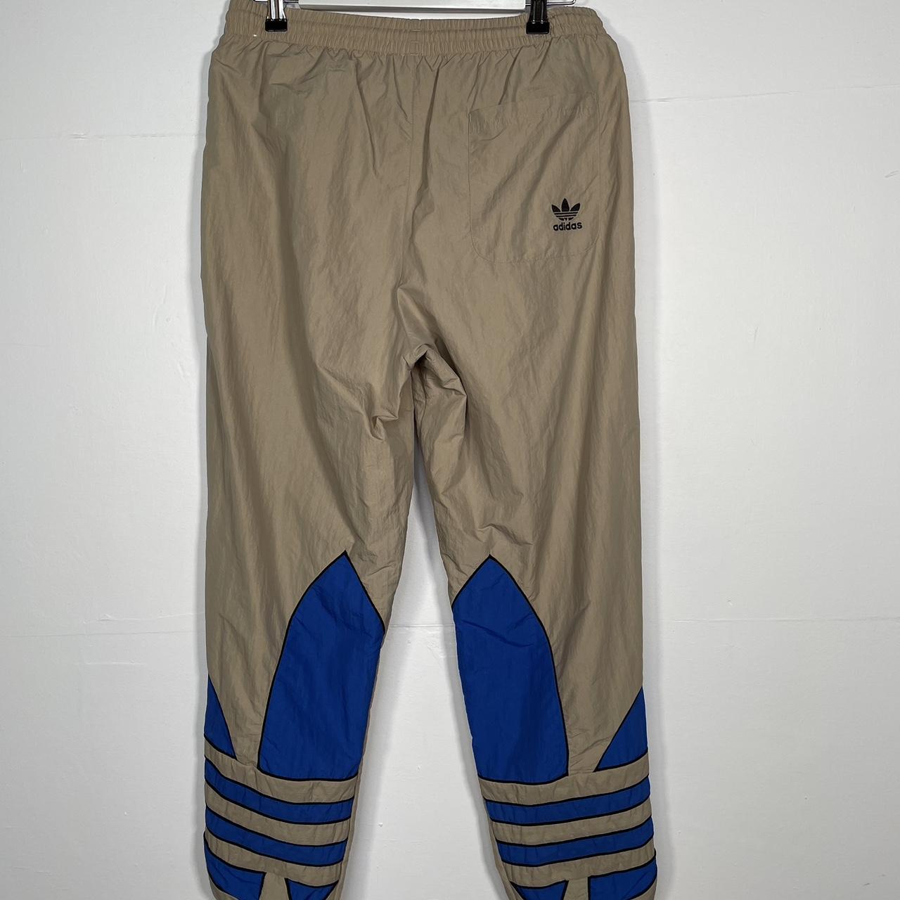 W280 Adidas tan tracksuit bottoms with blue logo... - Depop