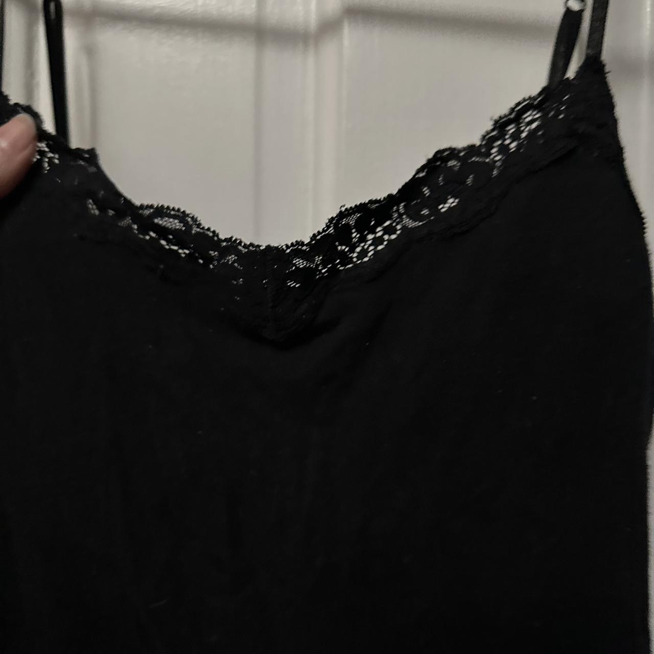 Fitted black tank top with lace details on the... - Depop