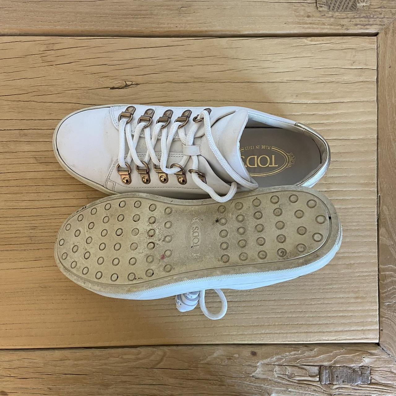 Tods white leather sneakers with gold buckle... - Depop
