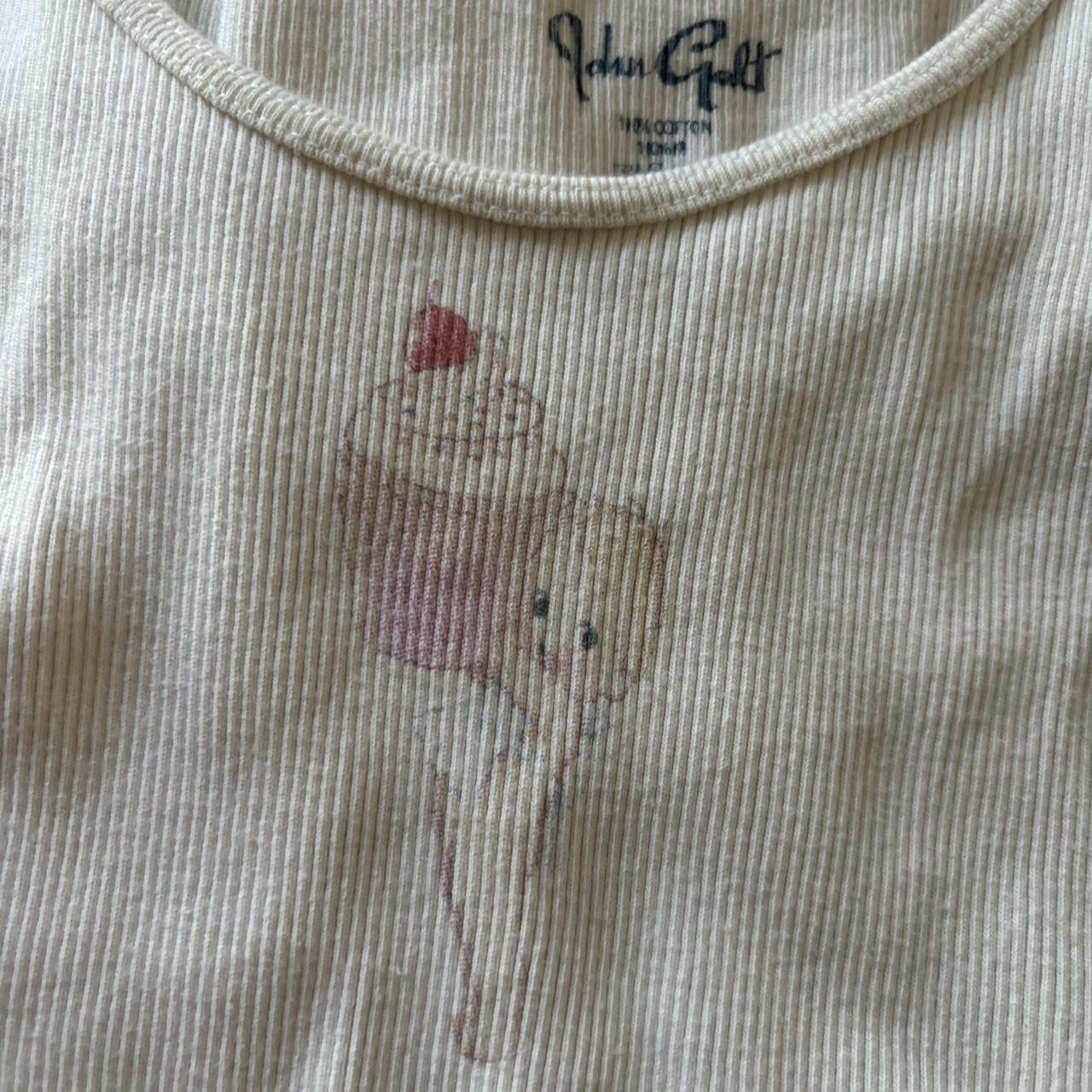 brandy melville/john galt cherub holding cupcake... Depop