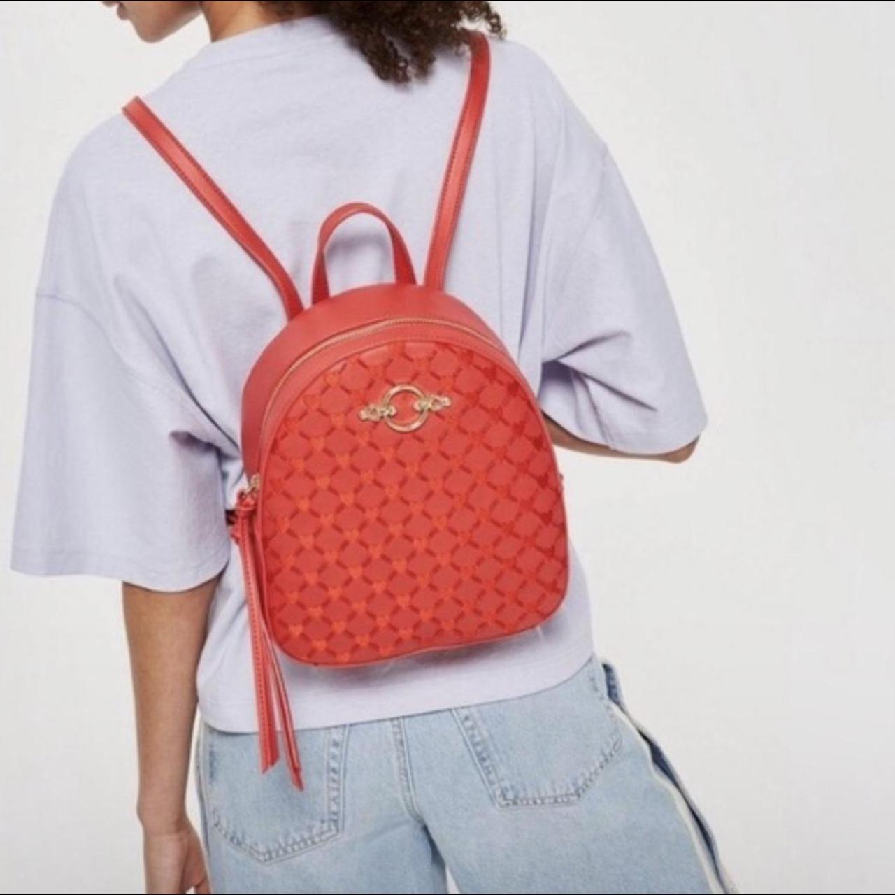 red mini backpack bag with heart detail.... Depop