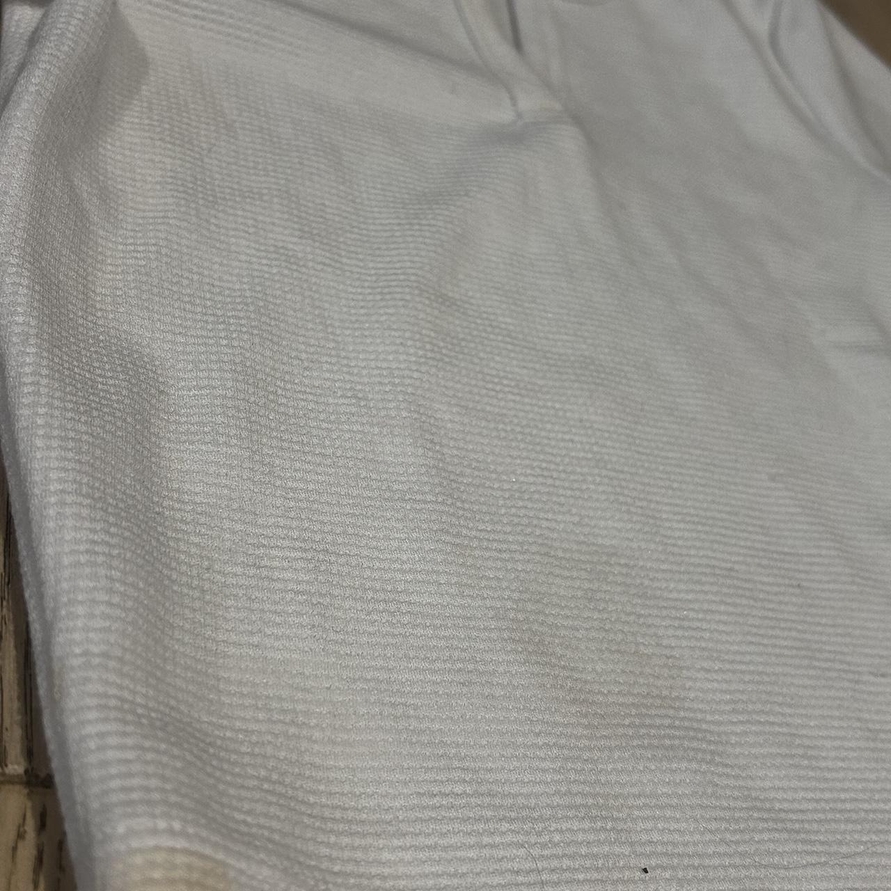 white aritzia baby tee has a mark on but not too... - Depop