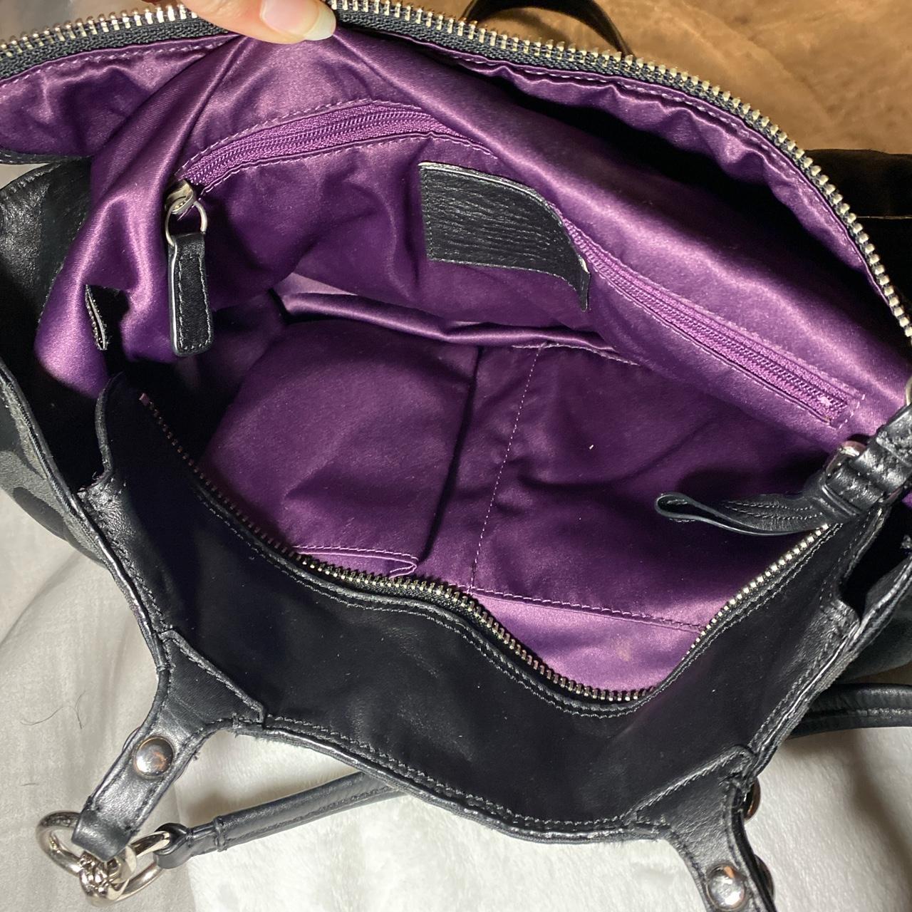 Black coach purse 2024 with purple inside