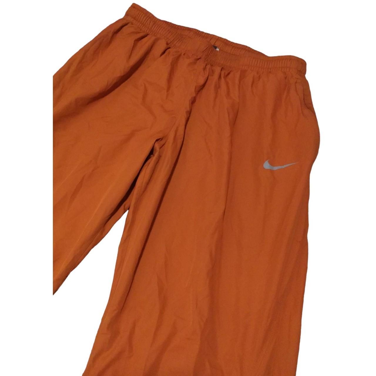 Nike track pants discount orange