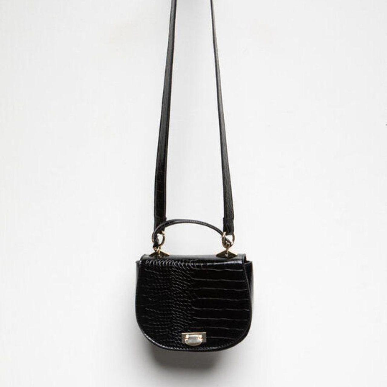 Faux leather structured saddle bag with an allover... Depop