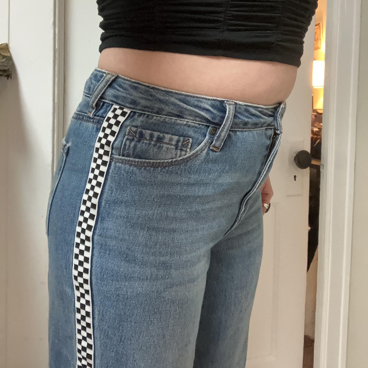 Jeans with checkered store patches