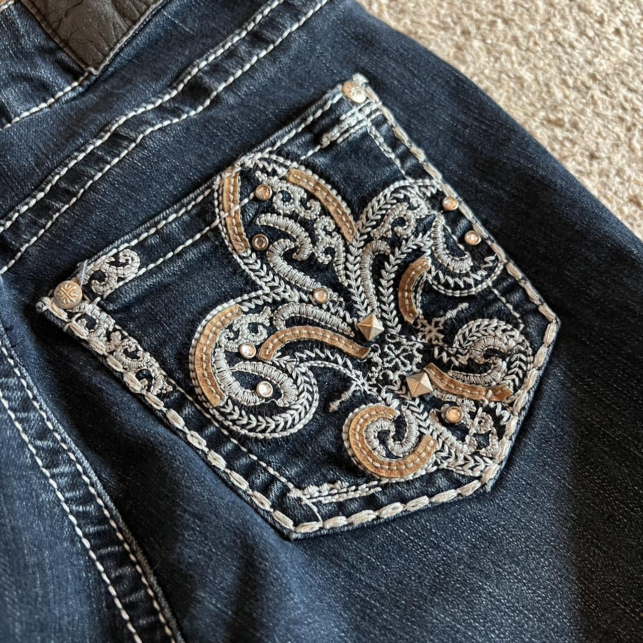 Flared dark wash low rise jeans with embroidered... - Depop