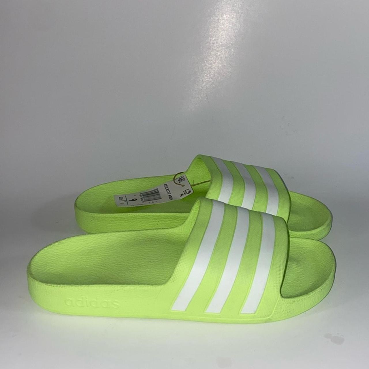 Adidas adilette slides in neon green and white. Depop