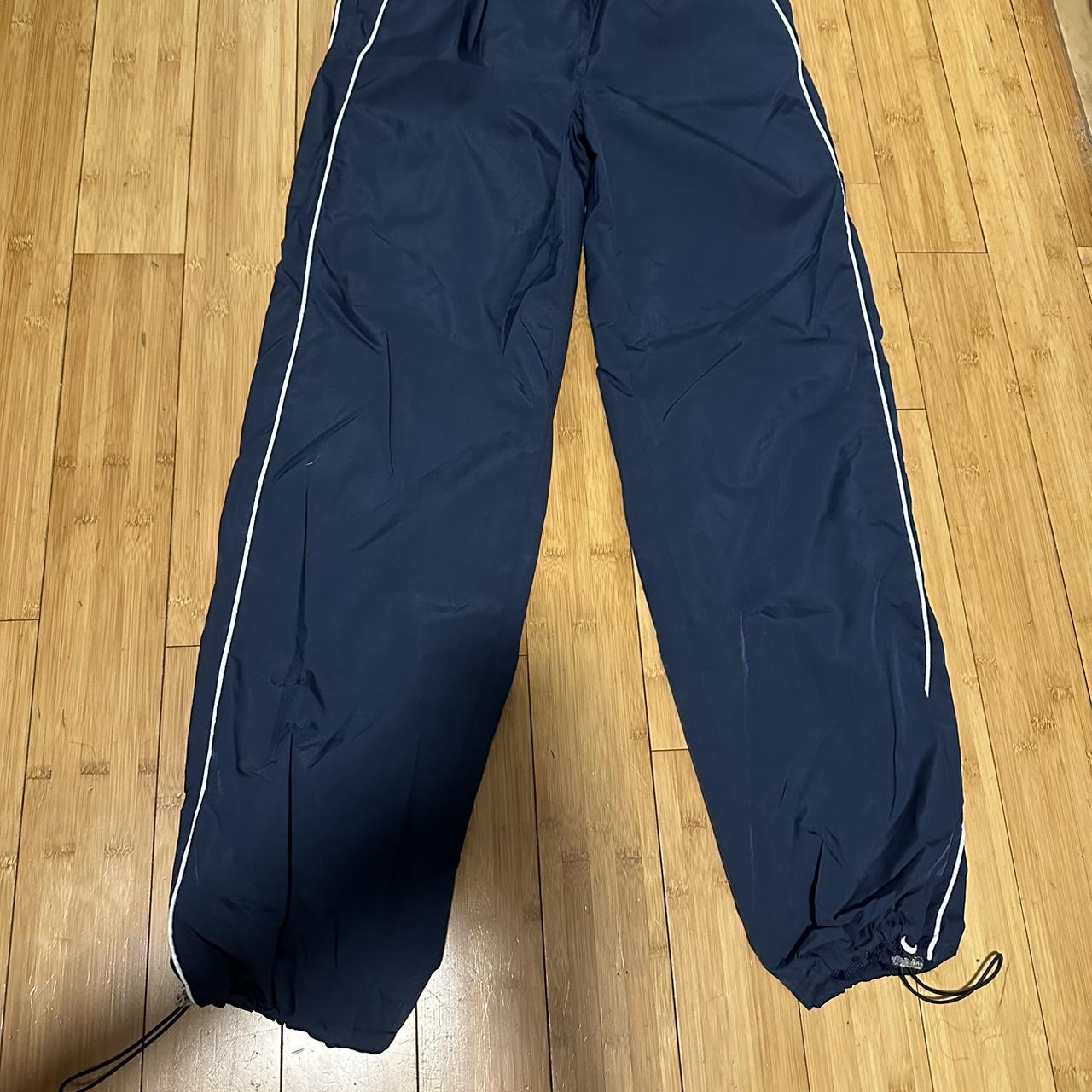 Blue Track Pants with two white lines on each side... - Depop