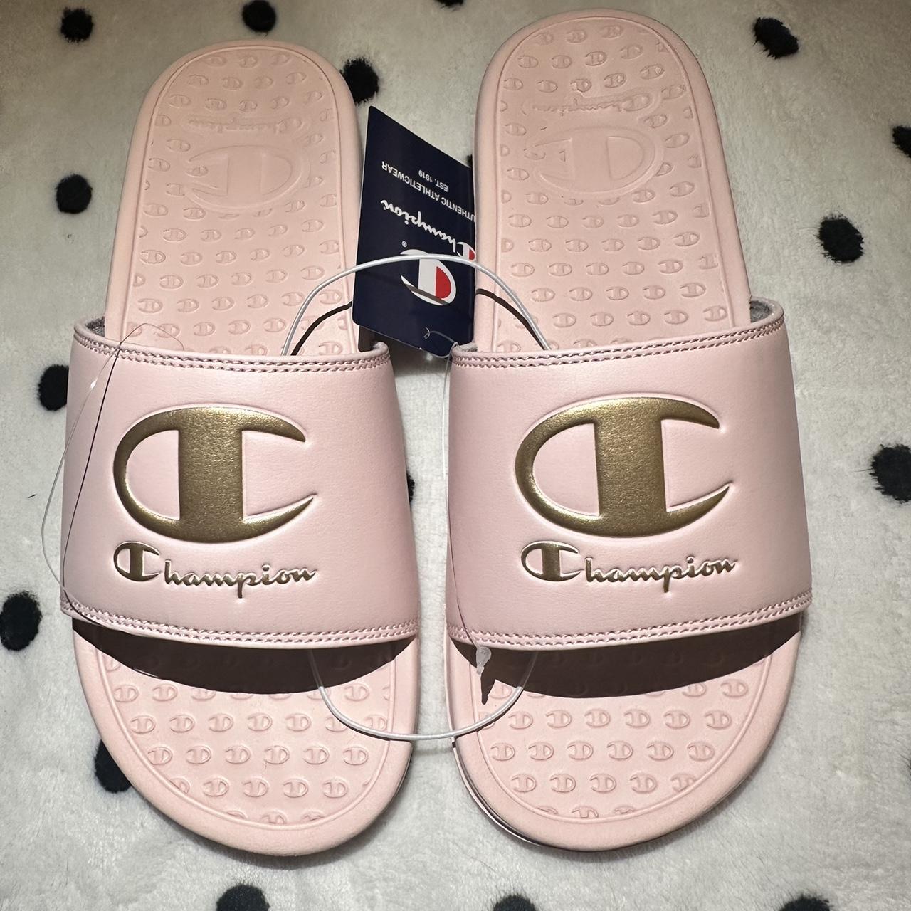 Champion pink slides with gold logo on front. Brand