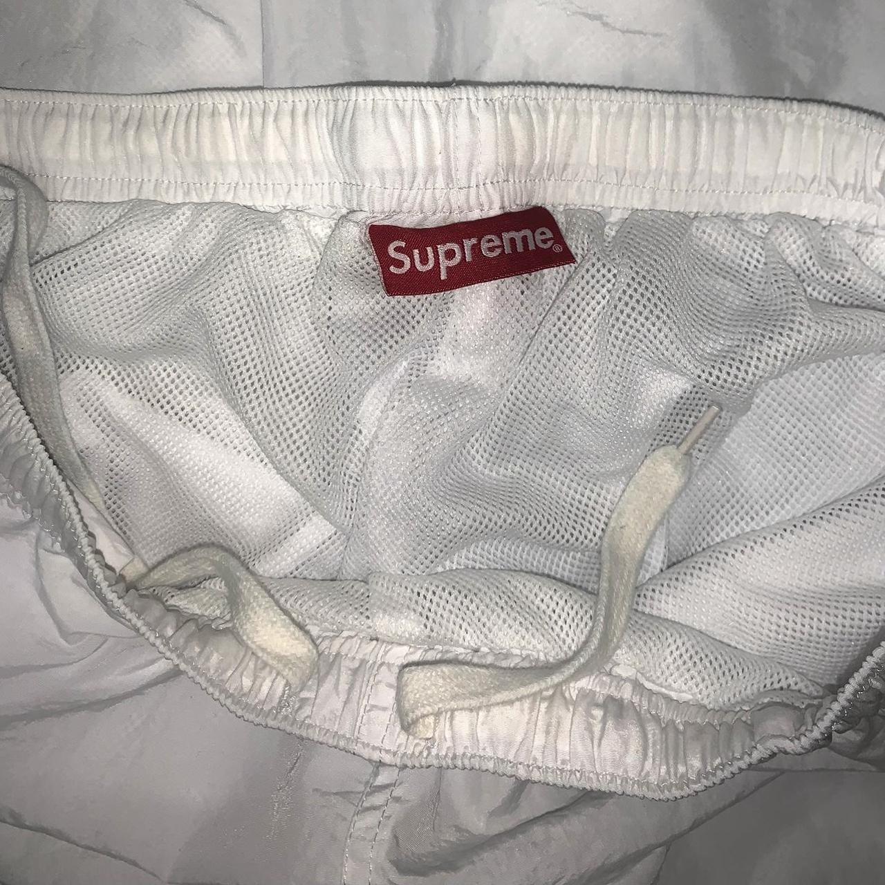 SUPREME CORNER ARC TRACK PANT. WHITE/NAVY BLUE....