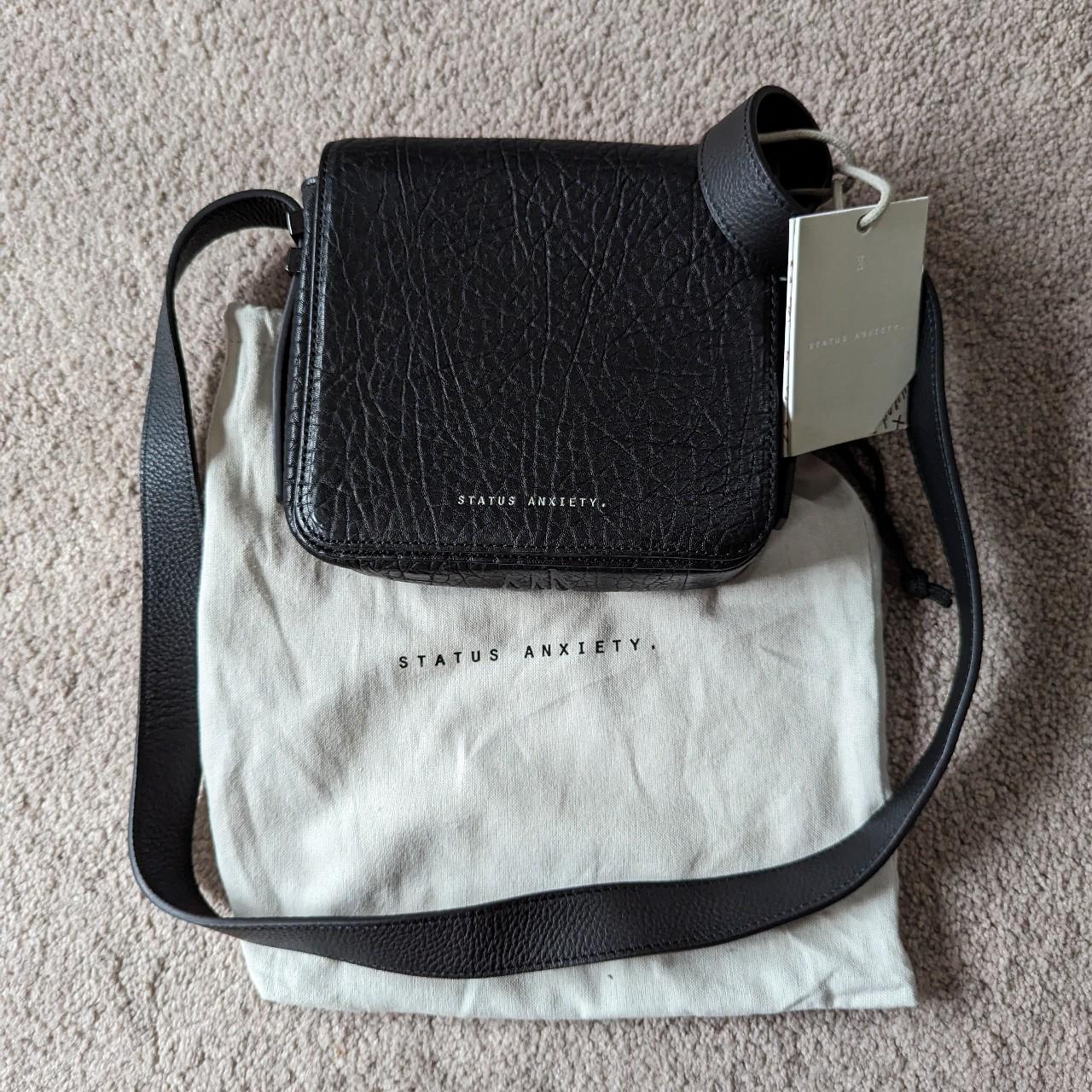 Status anxiety hot sale grey bag