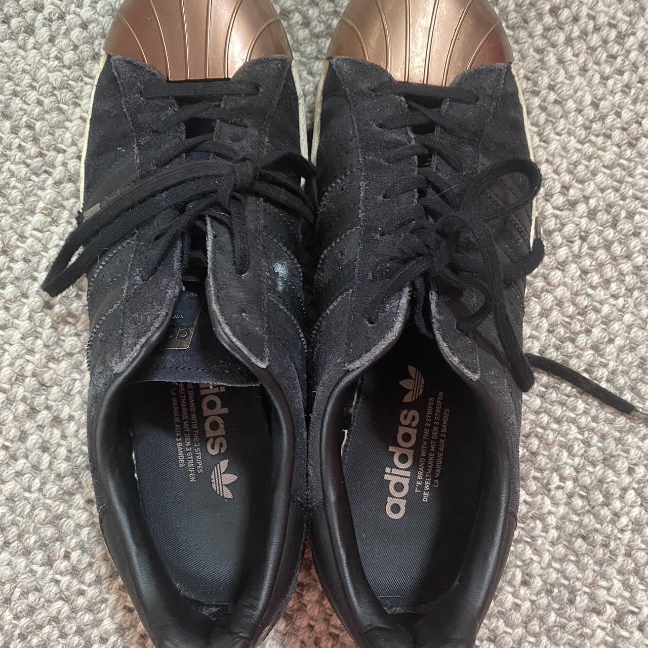 Black adidas shoes shop with rose gold stripes