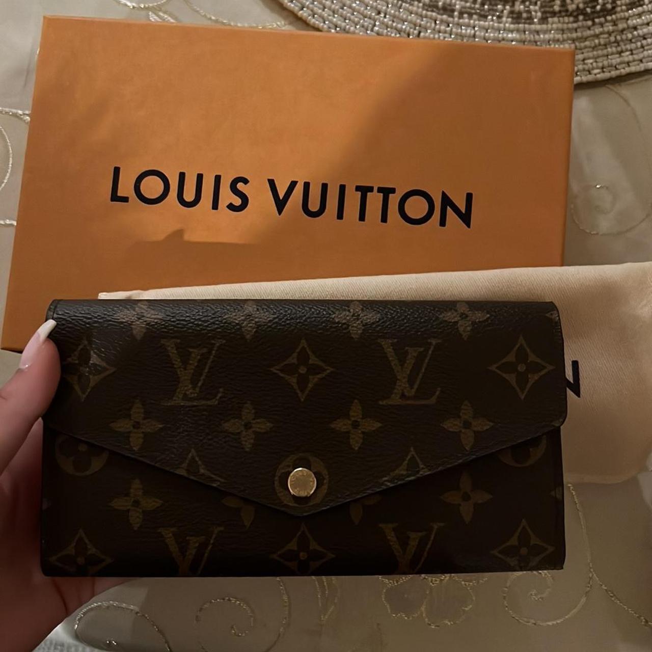 Slightly used Louis Vuitton wallet with the red on