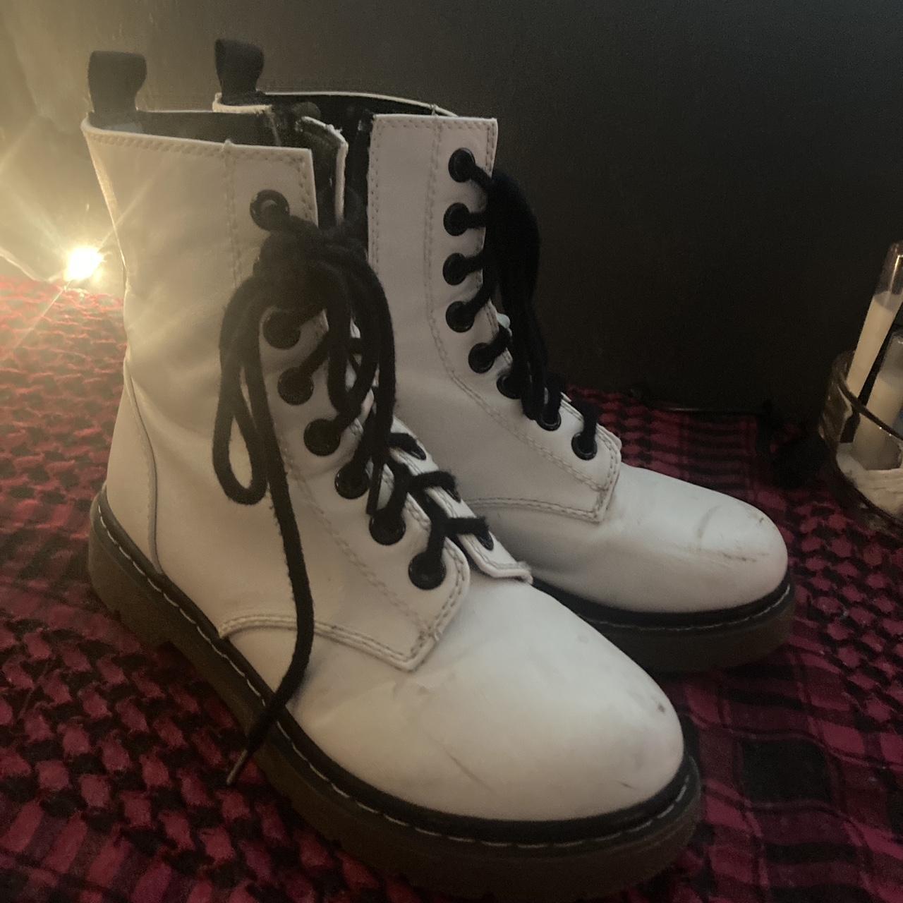 White and black off brand Dr. Martens boots. Size