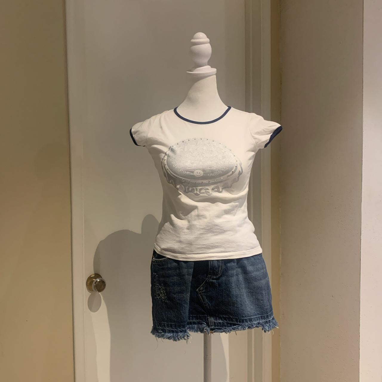 WHITE BABY TEE WITH DARK BLUE TRIM AND BOTTLE CAP... - Depop