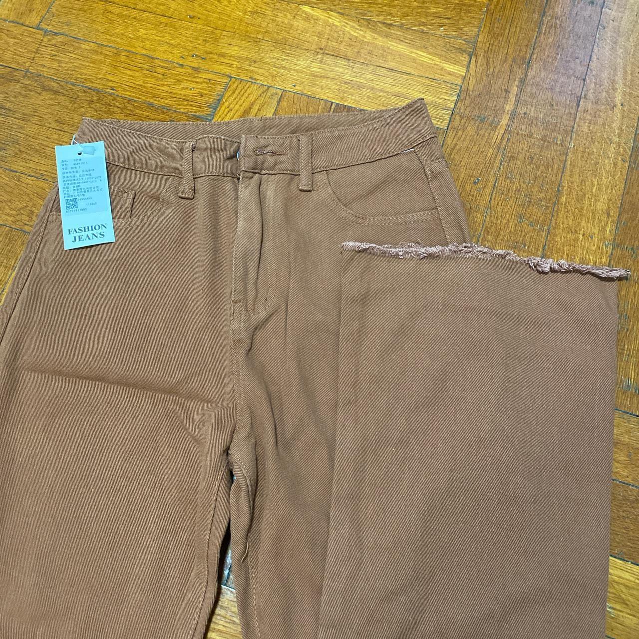 Brown high waisted jeans with frayed hem from... Depop