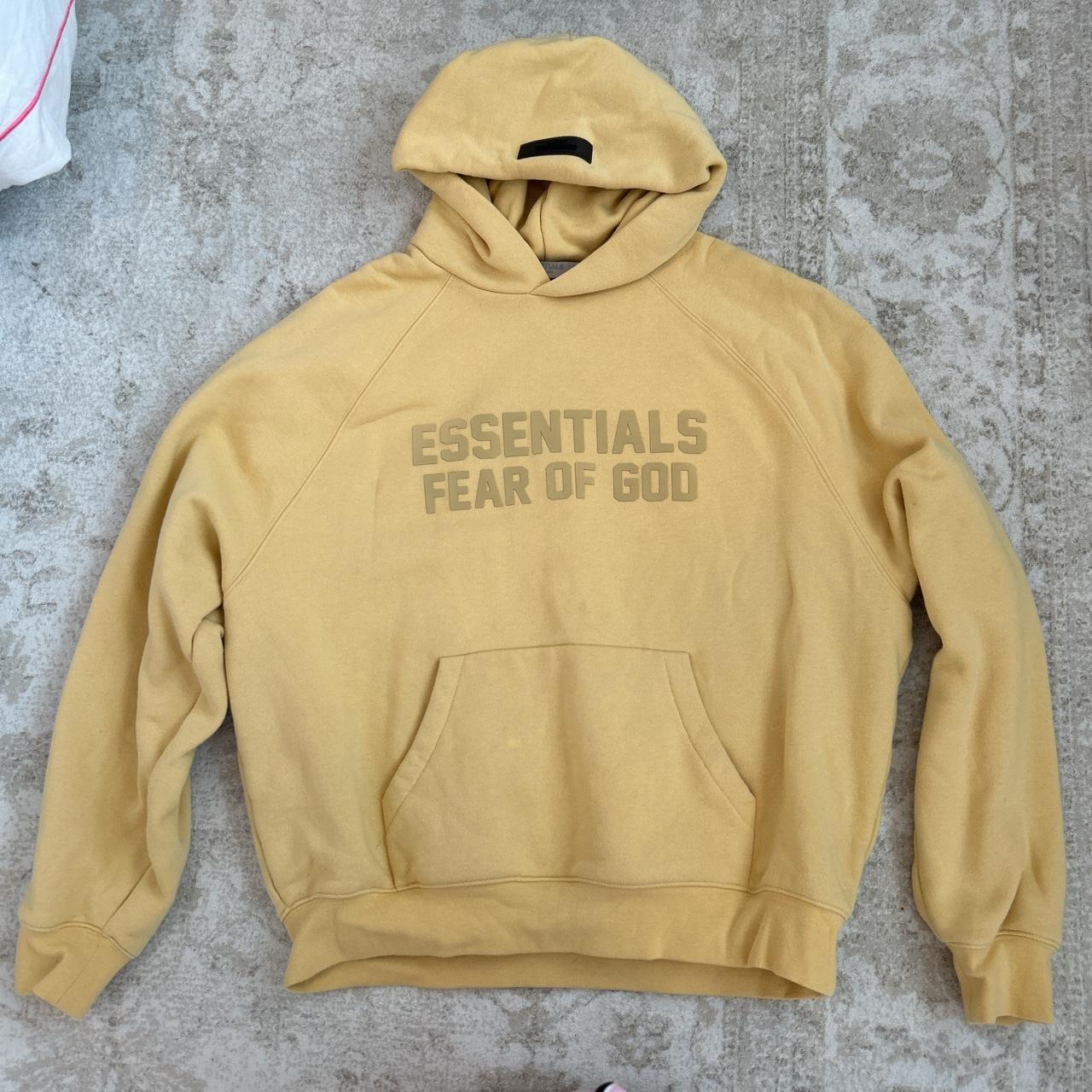 Fear of god essentials best sale yellow hoodie