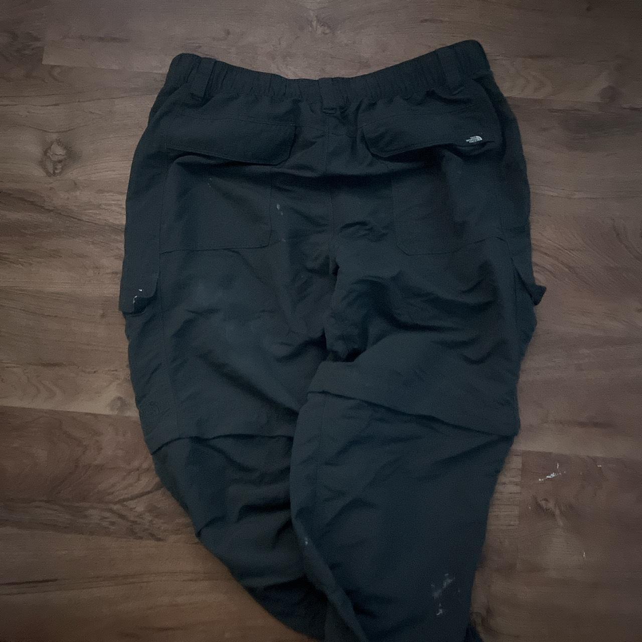 Grey north face cargos has some stains around the... - Depop