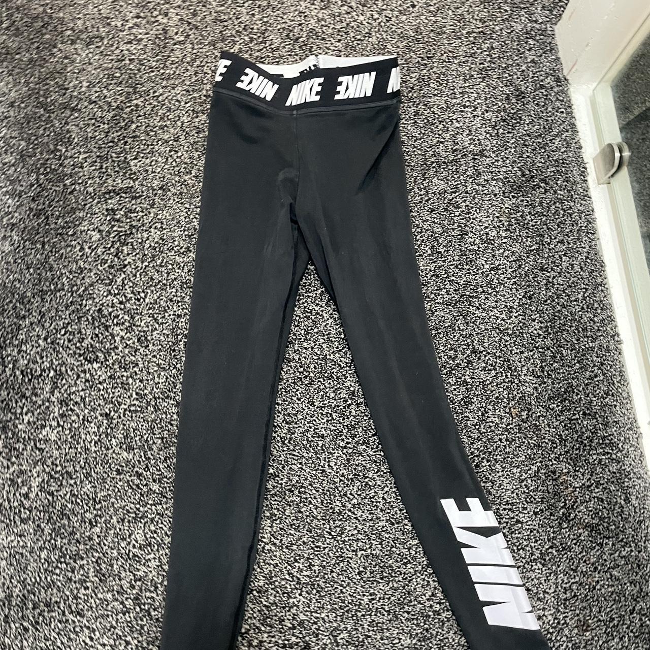 Black Nike leggings, with Nike written on the legs