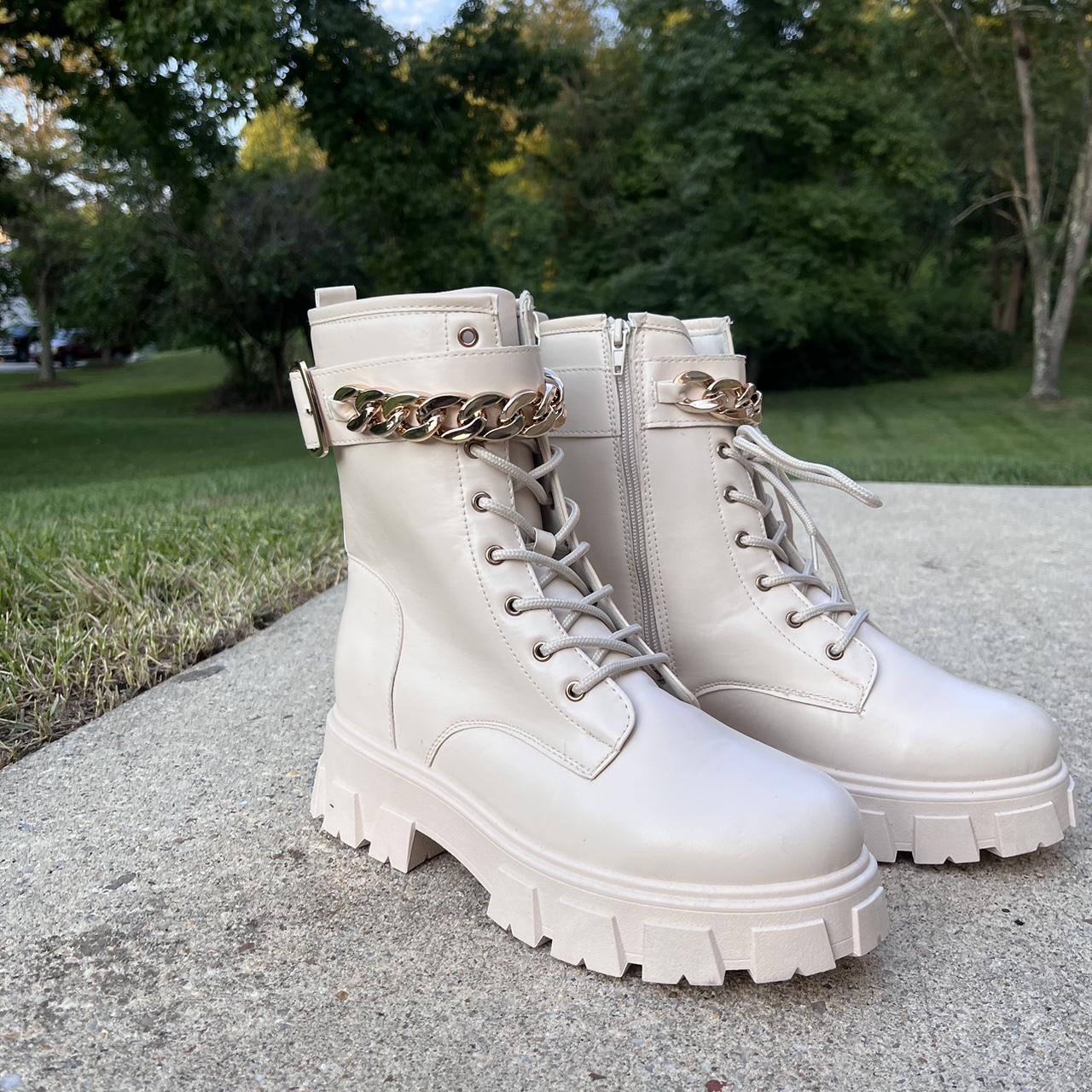 White boots with gold chain detailing,