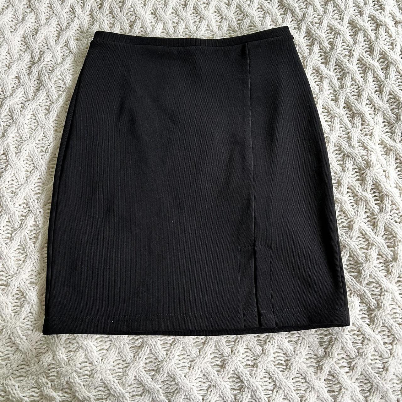 Vintage 90s black mini skirt has a small slit on