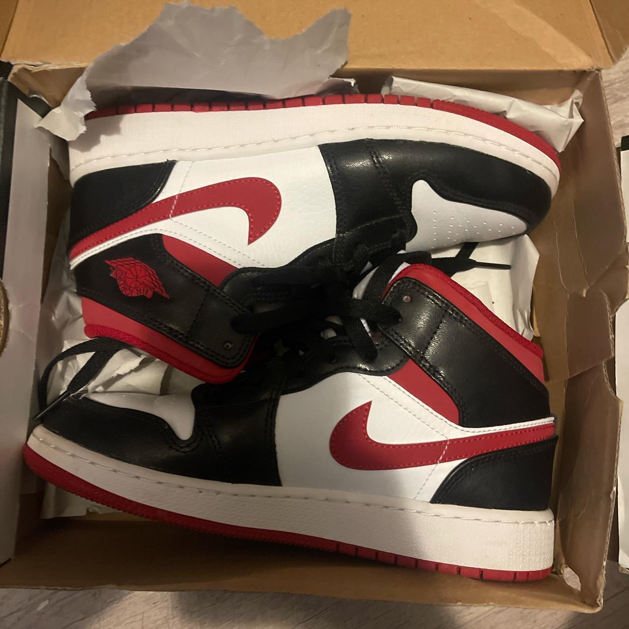 Half black half red best sale jordan 1s