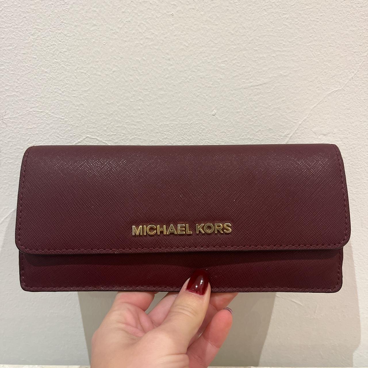 Michael Kors burgundy wallet. 8 card slots and 2