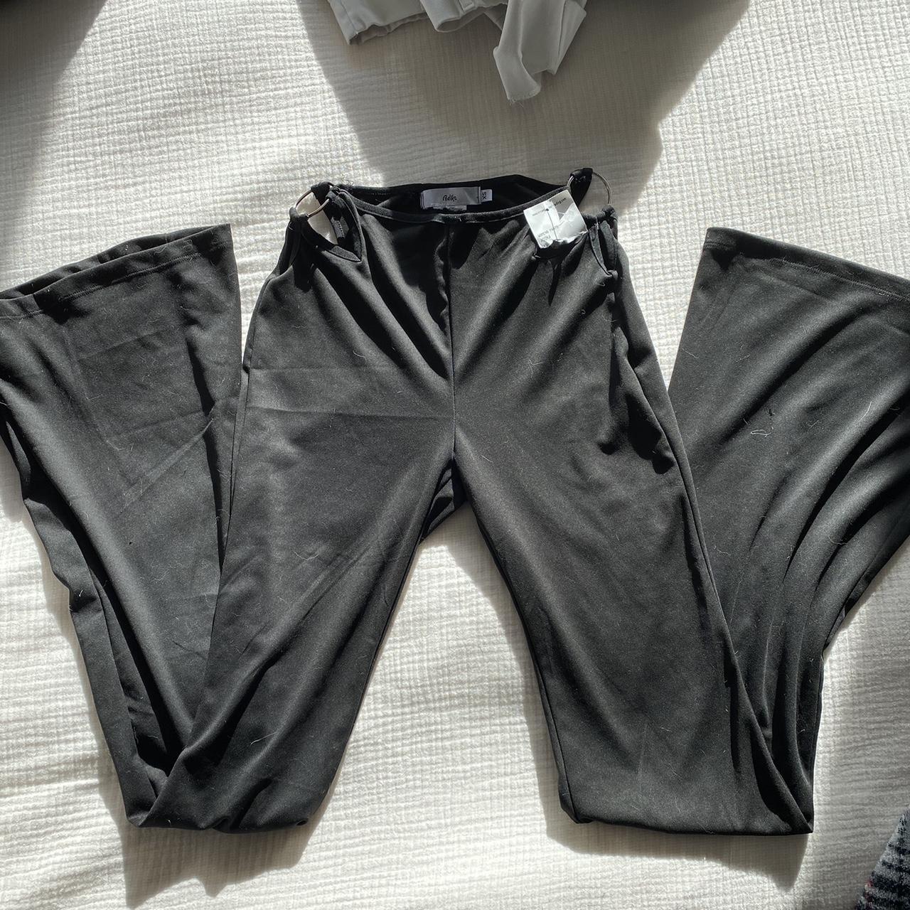 Black flare pants with cutouts and rings on the side... - Depop