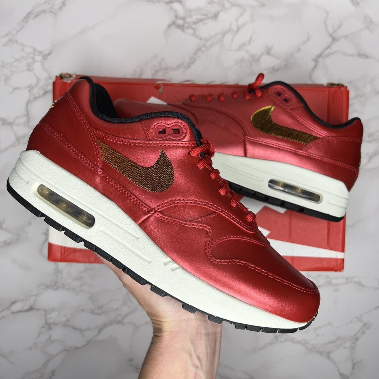 red and gold nike trainers