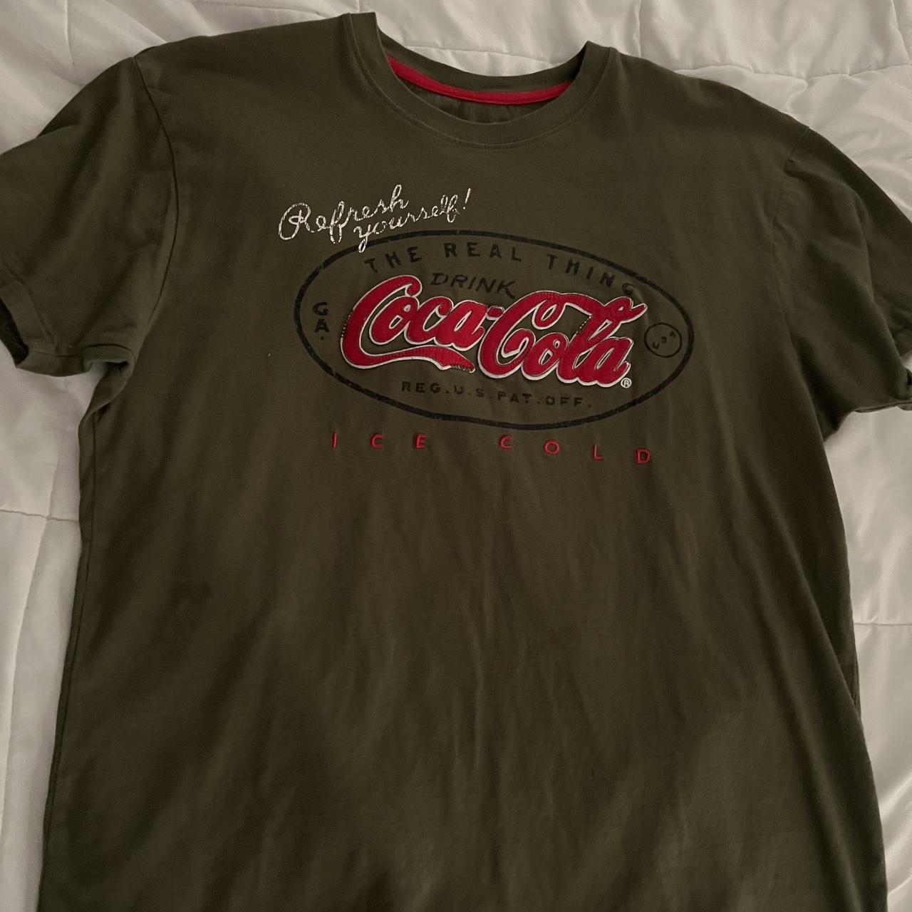 official coca cola shirt from the world of coca cola... - Depop