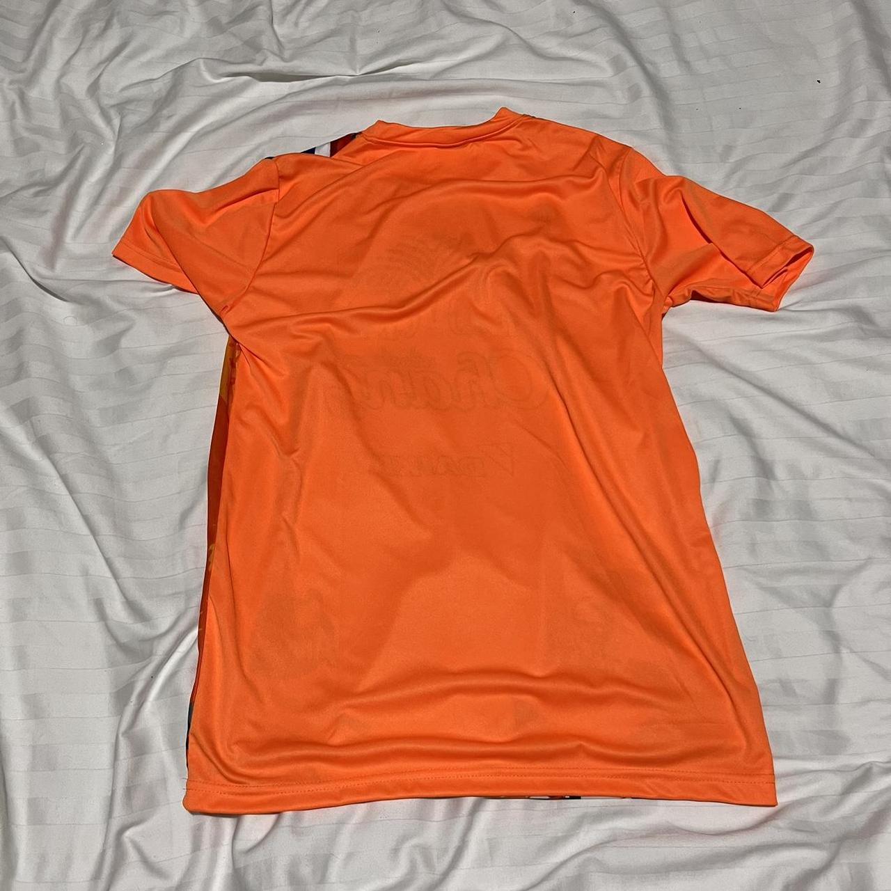 Chang orange football shirt Says size L but fits... - Depop