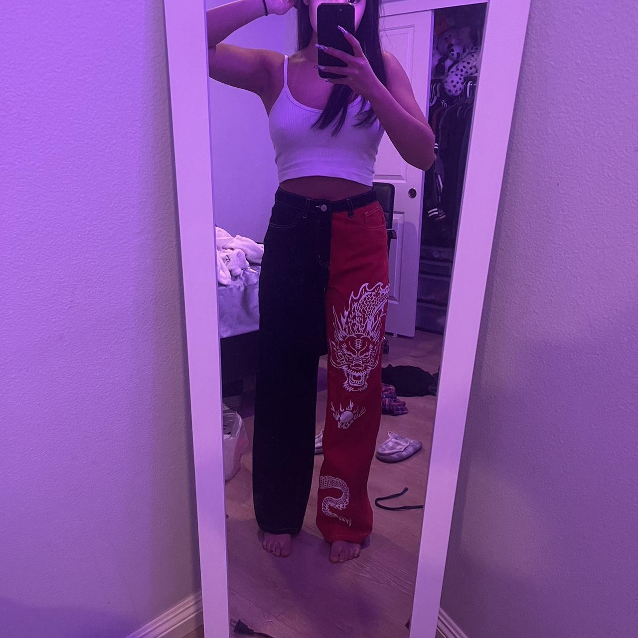 dragon jeans! half red half black with white dragon... Depop