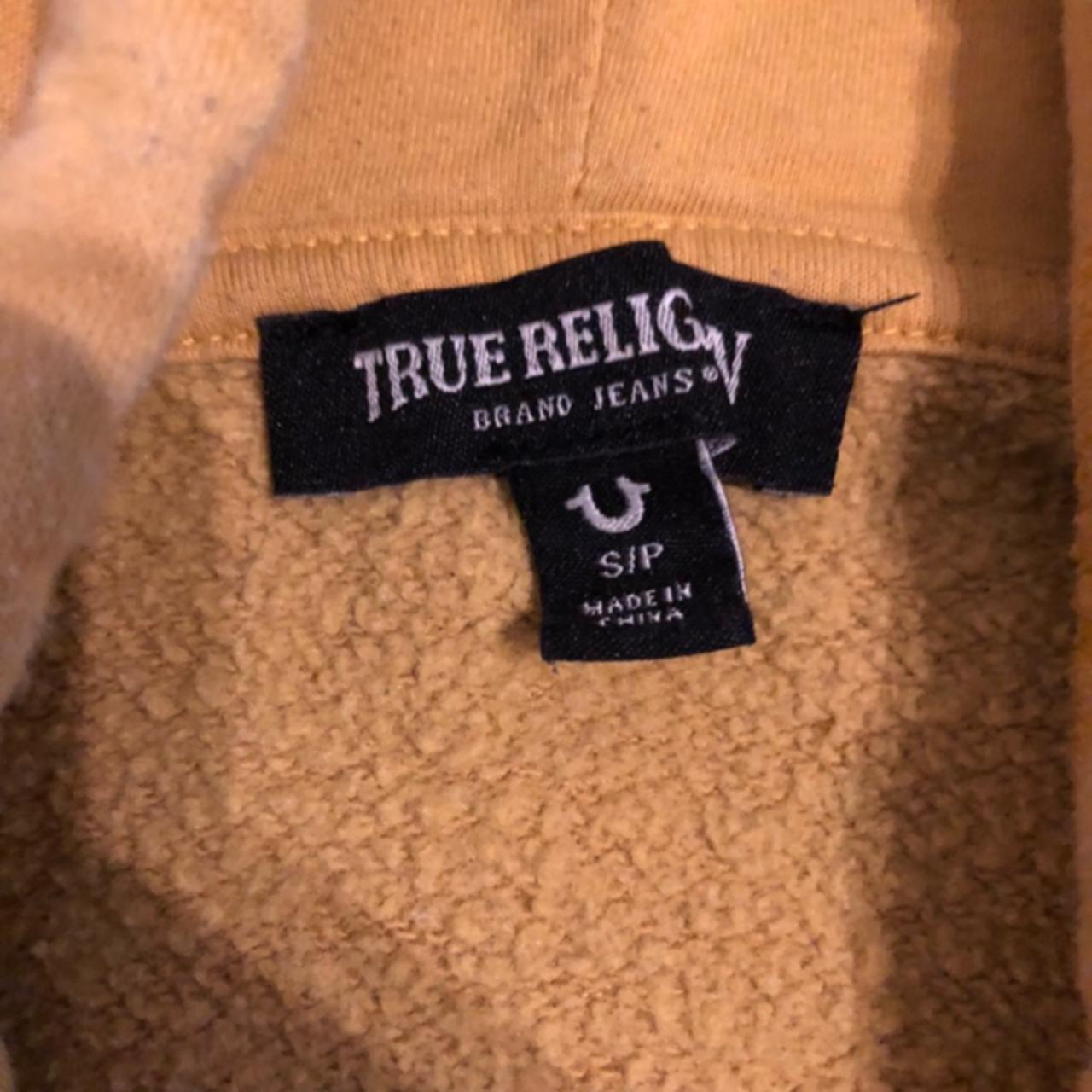 Size Small yellow True Religion hoodie. Black stain... Depop