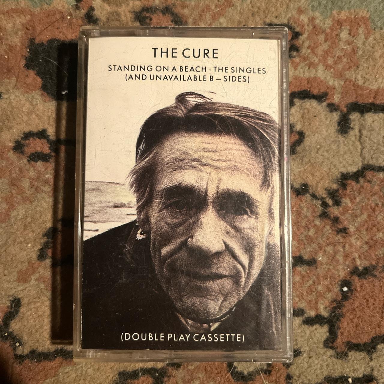 The Cure standing on a beach the singles and Depop