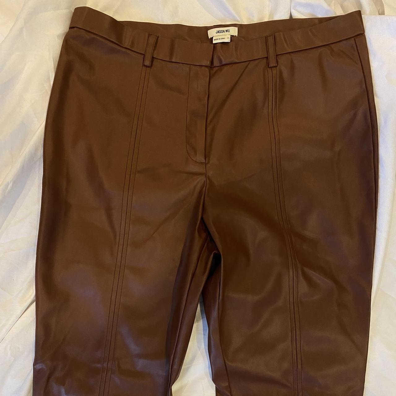 Brown faux leather pants with slits at the bottom of - Depop