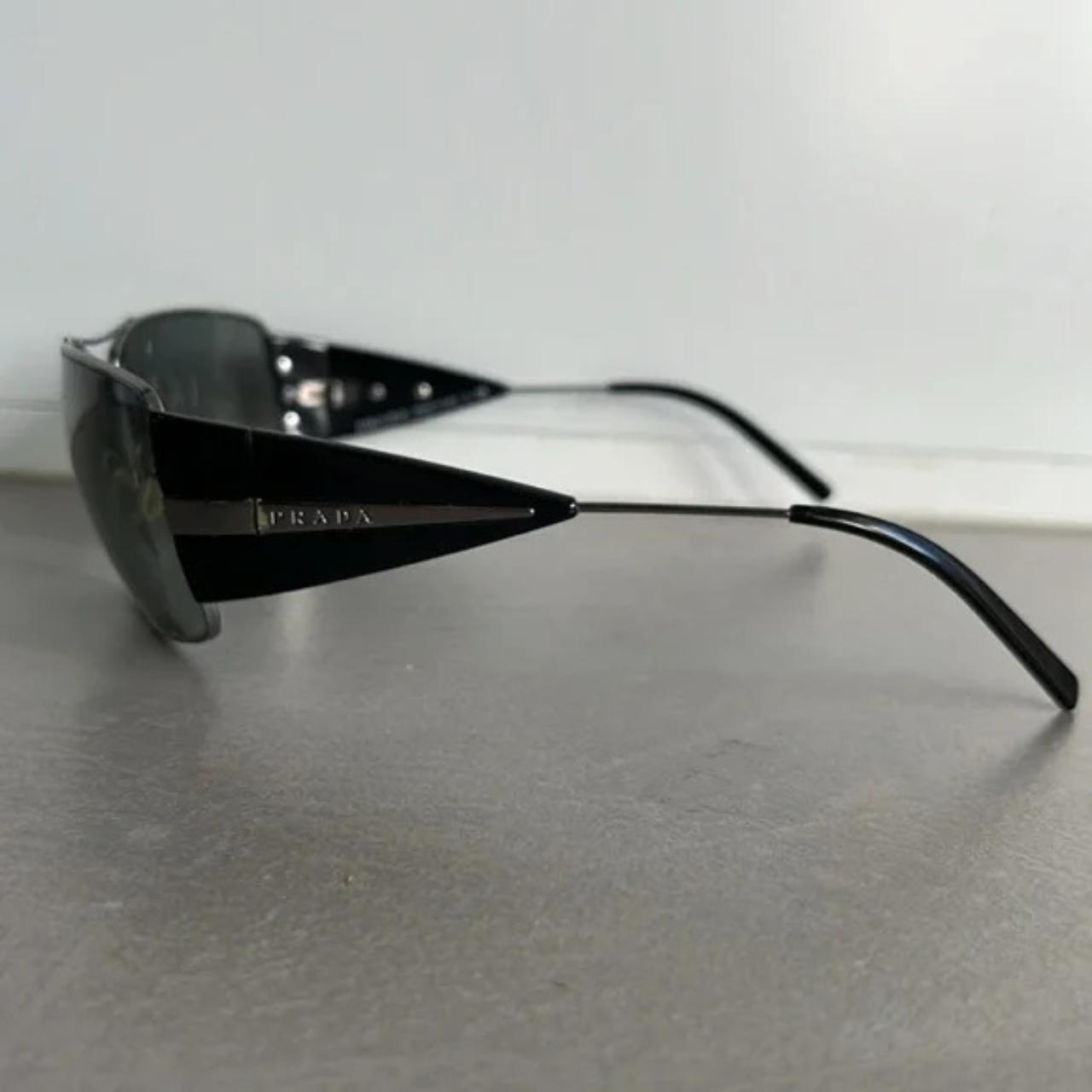 These SPR55H sunglasses from Prada are made with a. Depop