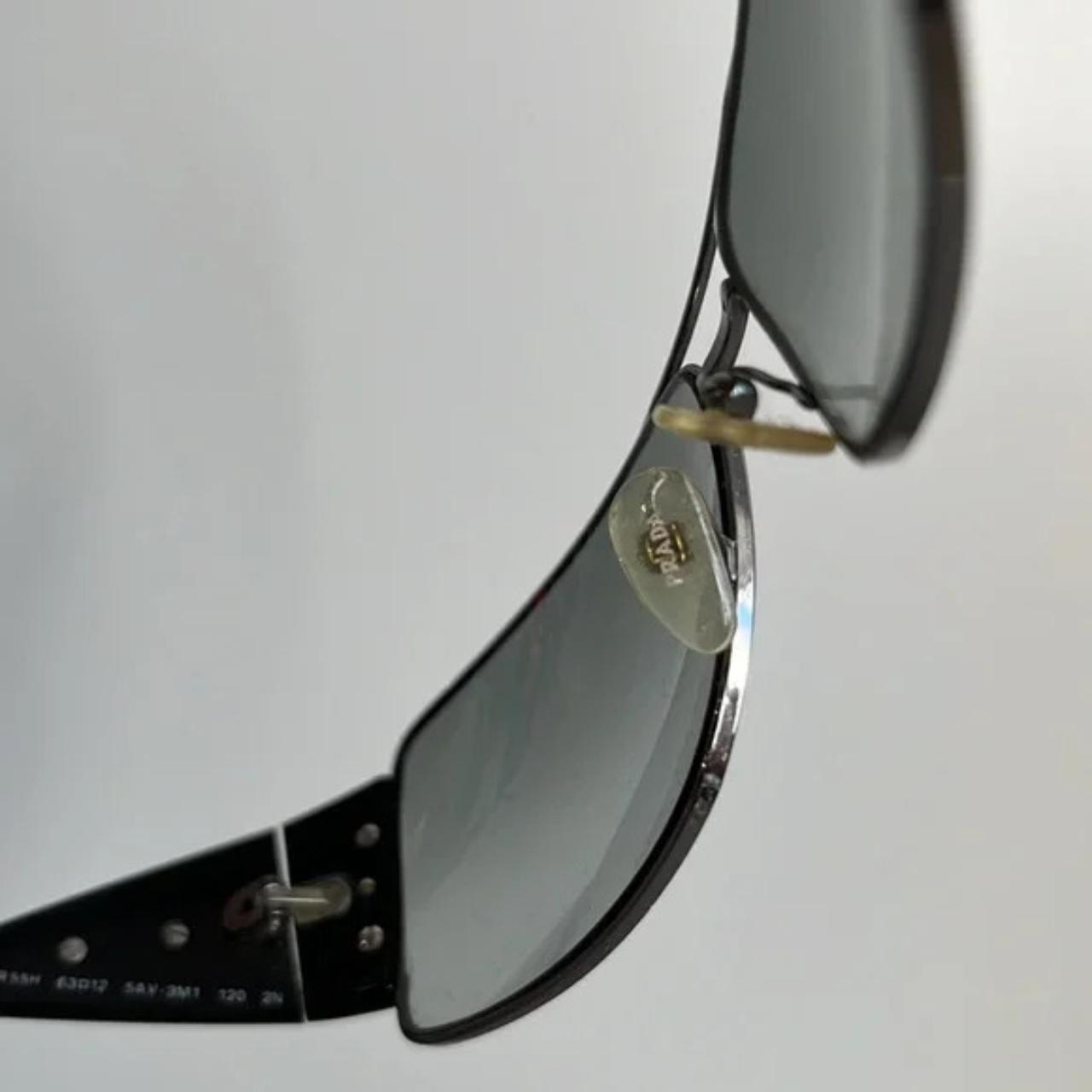 These SPR55H sunglasses from Prada are made with a. Depop