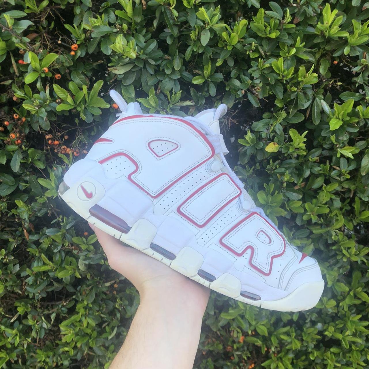 white nike shoes with red logo