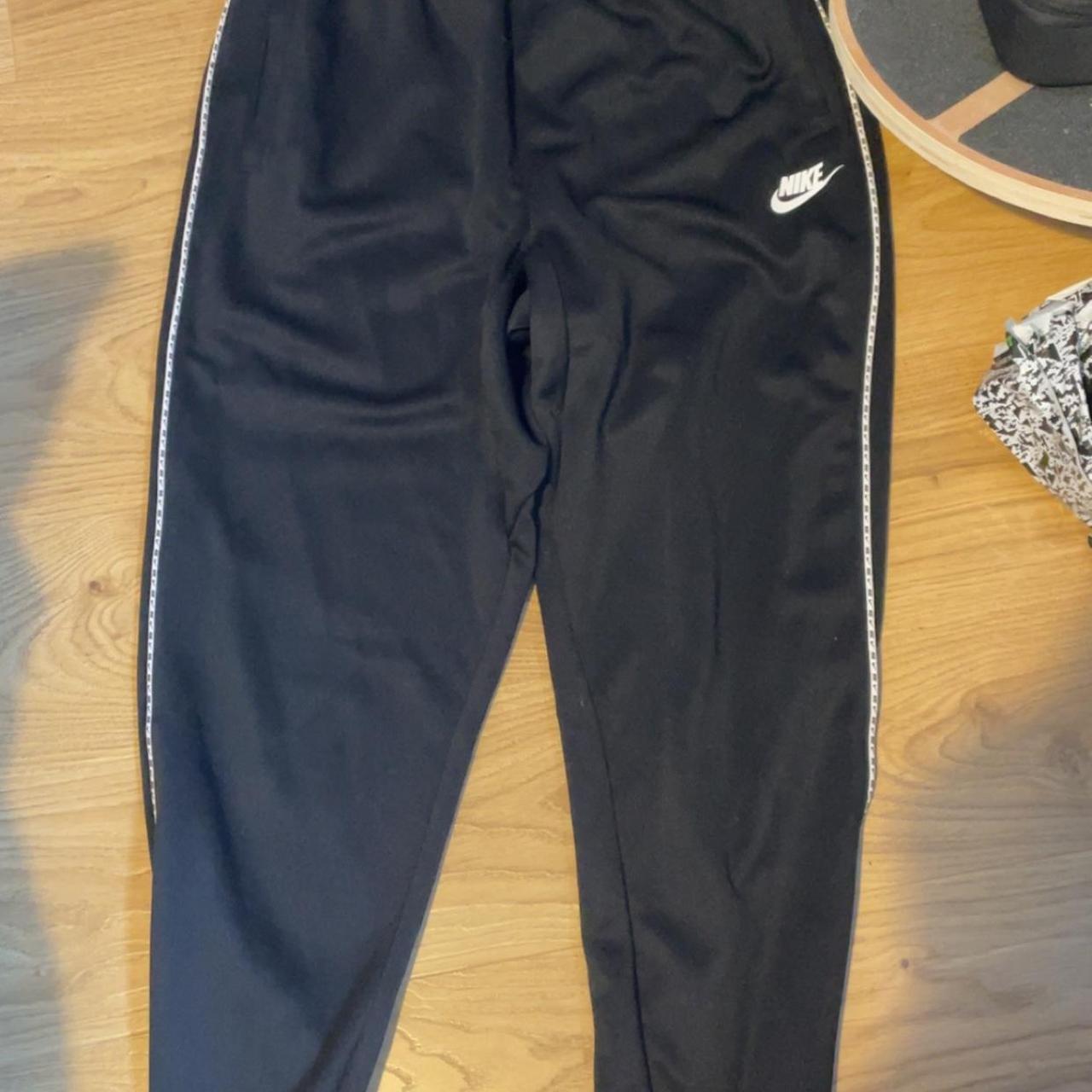 Black Nike sweatpants size L rip on the but - Depop