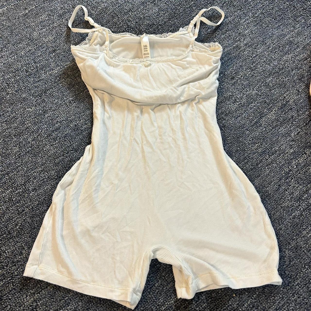 Skims white one piece Sold out on skims for $78,... - Depop