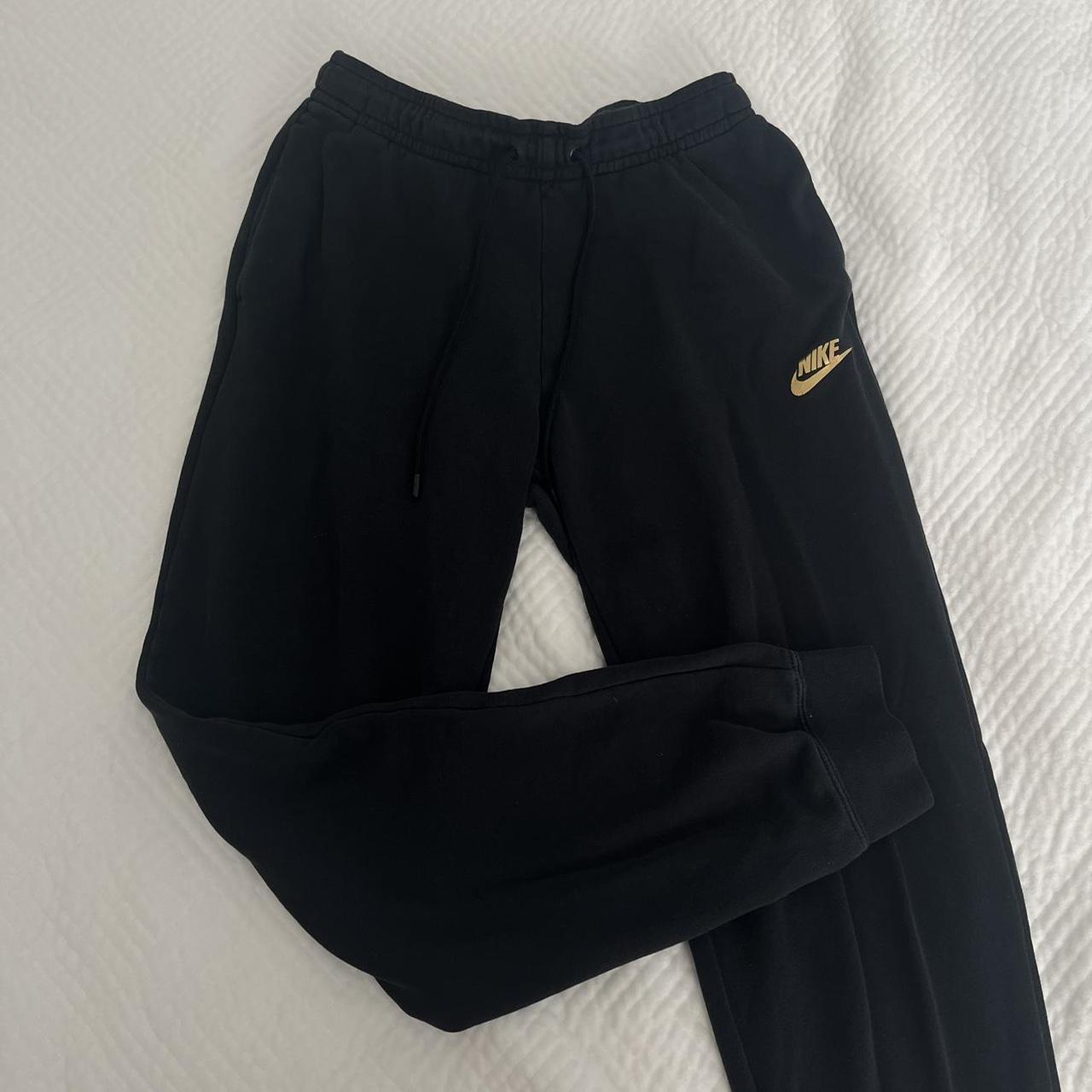 Womens black nike on sale with gold swoosh