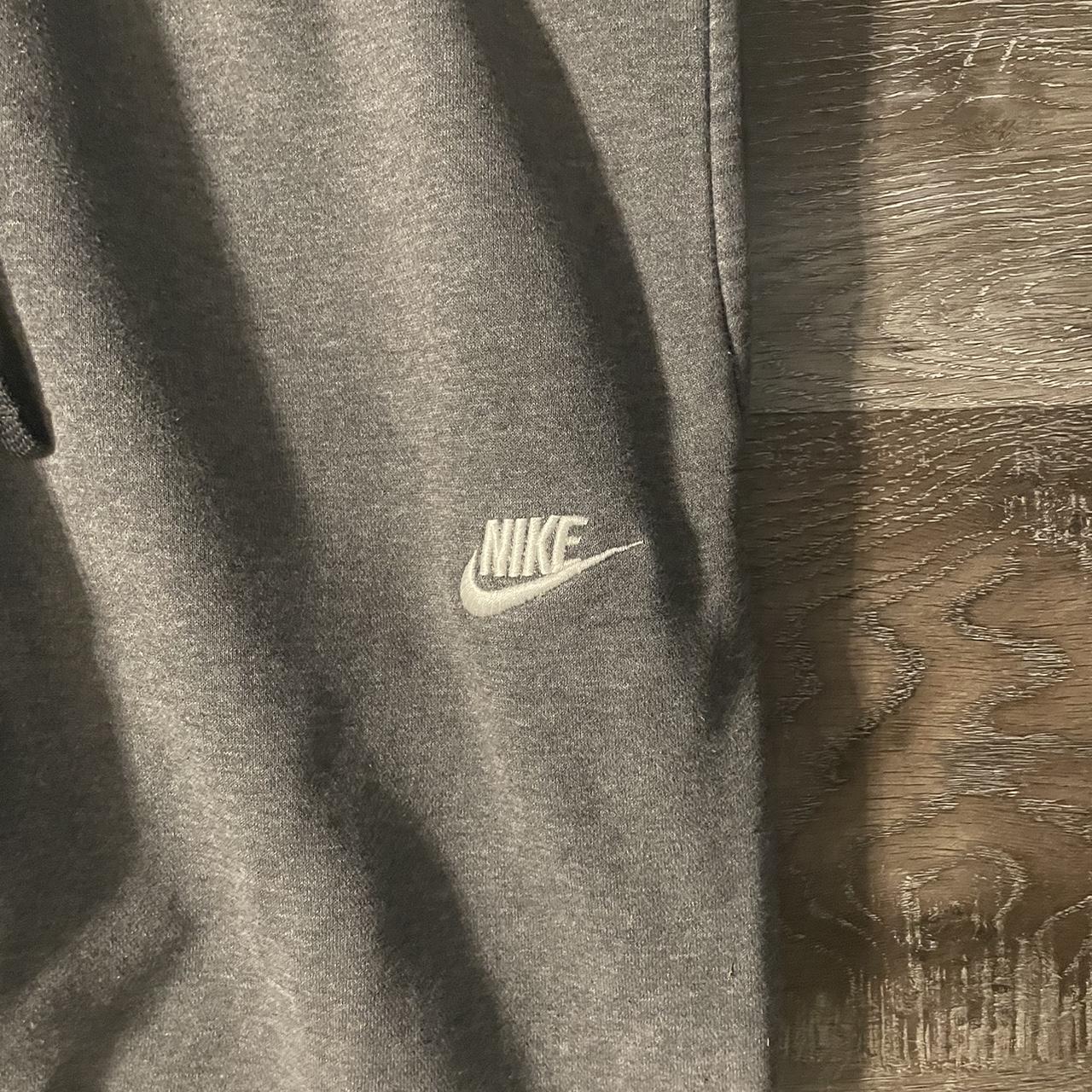 Grey Nike sweats baggy fit. Small bleach stain on... - Depop