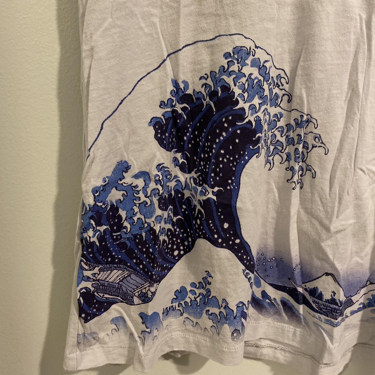 Hokusai themed top from Uniqlo. Has a small stain... - Depop