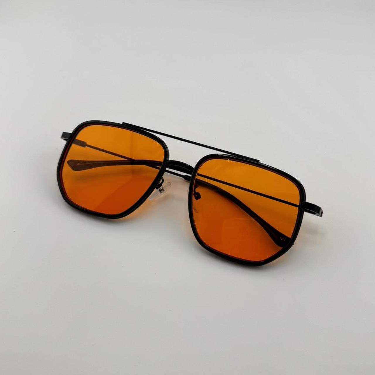 Retro black aviator sunglasses with orange lens