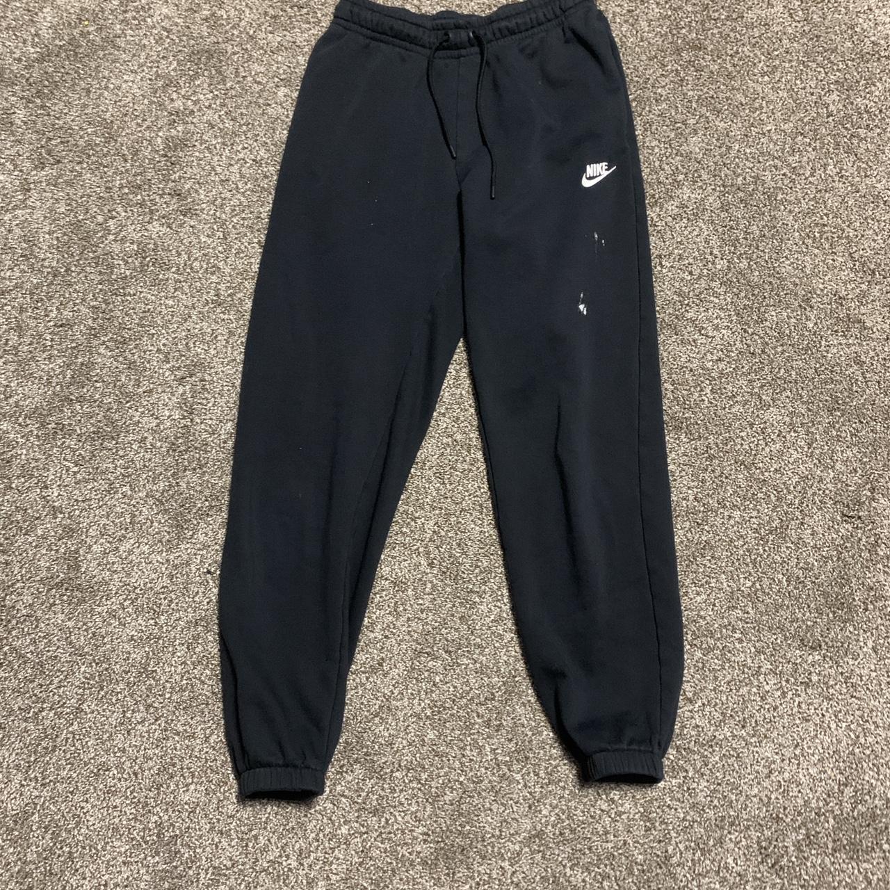 Black Nike sweat pants with minor white paint stain... - Depop